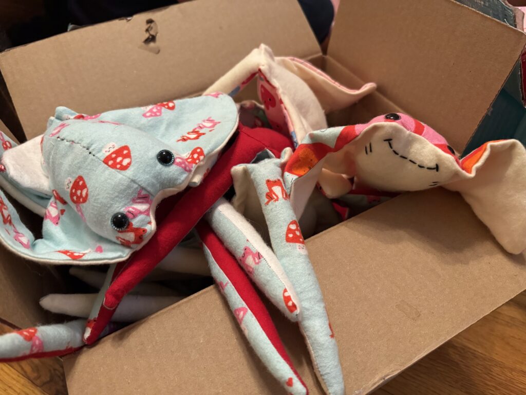 Box of plushie manta rays